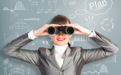 business woman looking through binoculars