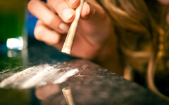 Young woman snorting cocaine