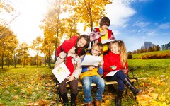 Kinder und Jugendliche auf einer herbstlichen Wiese.